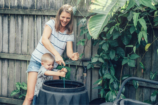 A mother composts with her young son