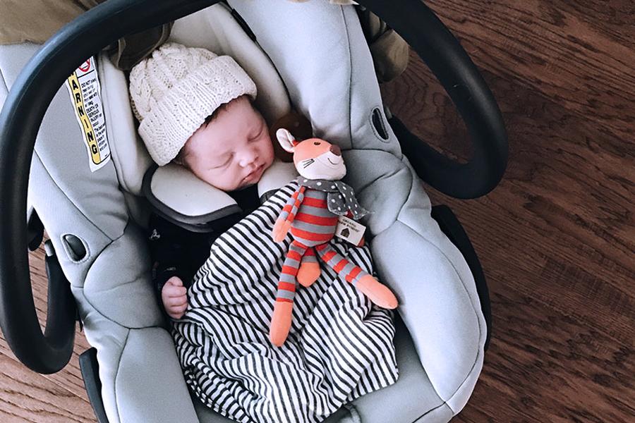baby sleeping in car seat at night