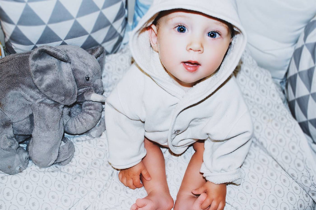 A baby wearing a robe 