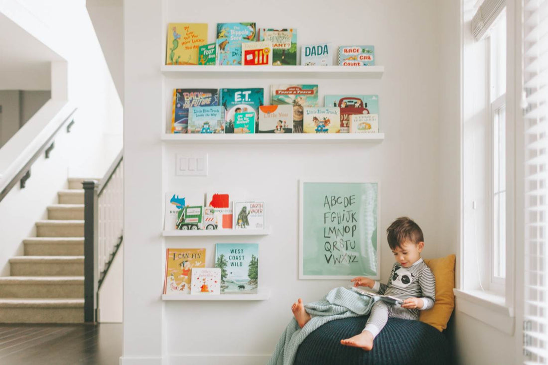 Children's books about kindness and empathy - toddler boy reading a book