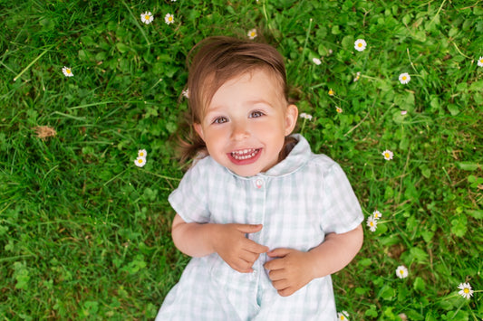 Baby girl laying in a patch of clover