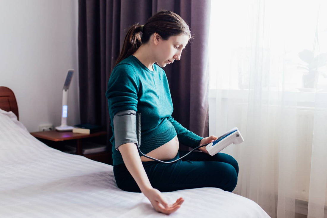 pregnant woman measuring blood pressure 