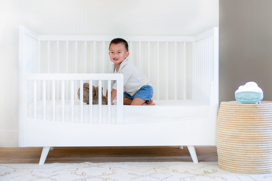 Toddler in bed using SNOObie as an OK-to-wake alarm