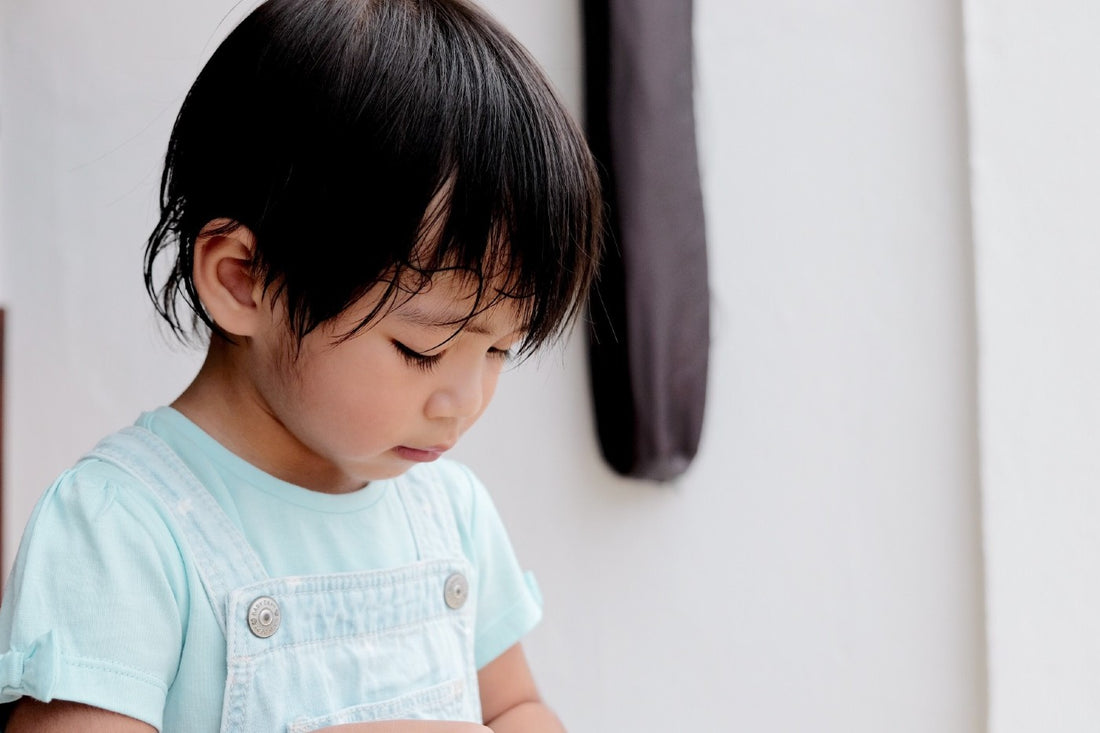 toddler looking sad