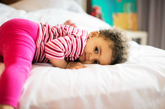 Sleepy toddler on bed