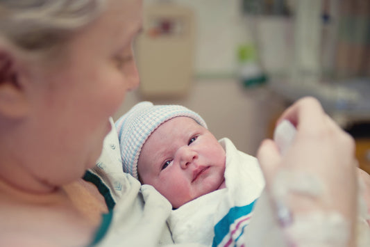 A mum holds her newborn baby